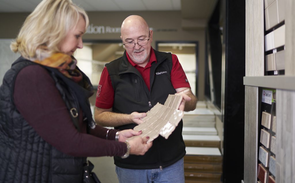 Mark Gantly, Tile Town Richmond store manager, helps a customer choose tiles and grout 