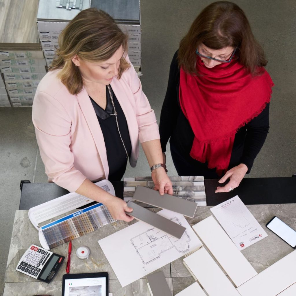 TileTown design consultant reviewing tile samples and grout options with a customer.